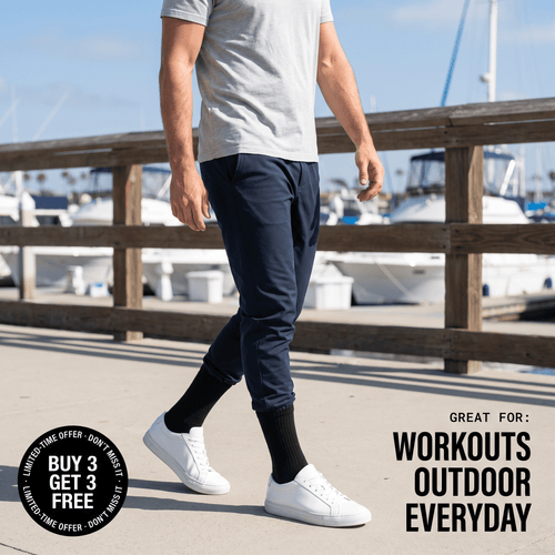 Man walking waterfront wearing black alpaca crew socks